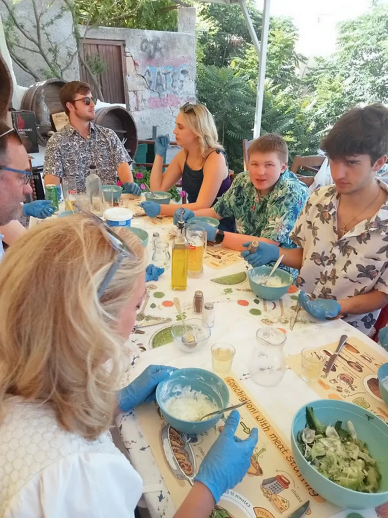Guests in gloves shaping mezze dishes at the table during the masterclass