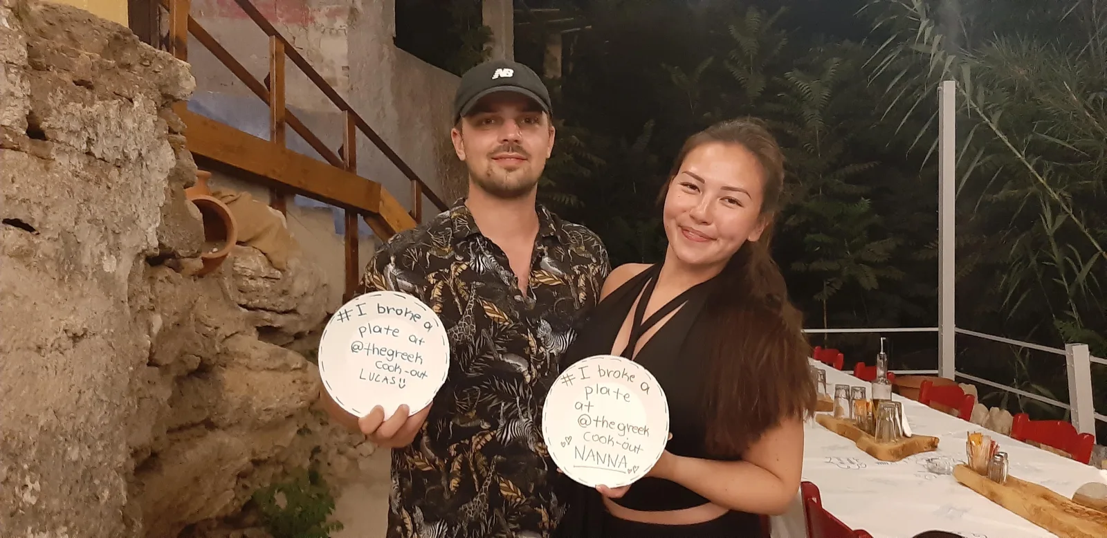 Two guests holding painted plates ready for the plate breaking
